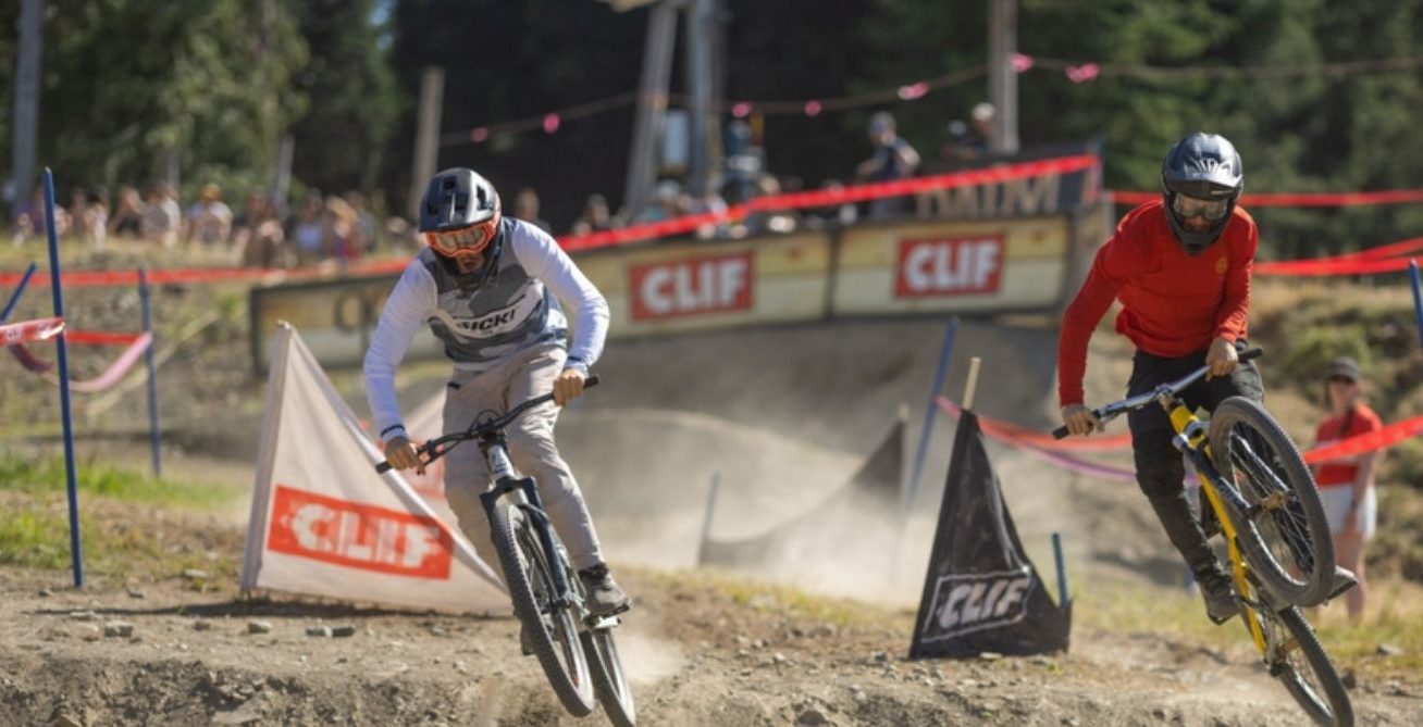 Dual slalom racers past branded course markers
